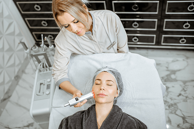 Practitioner performing a facial treatment