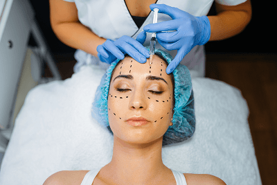 Injectable treatment by a gloved practitioner