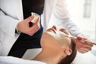 Practitioner applying skincare to a client